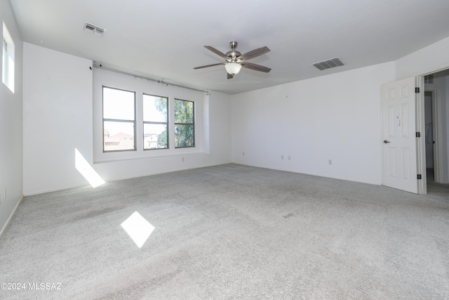 unfurnished room featuring ceiling fan and carpet floors