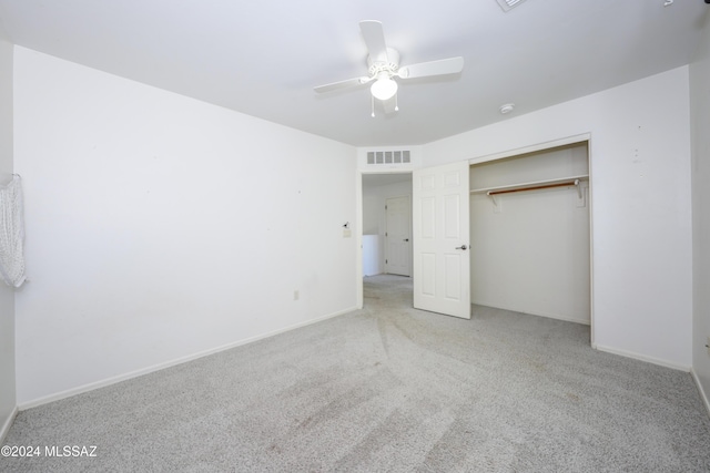 unfurnished bedroom featuring ceiling fan, a closet, and light colored carpet