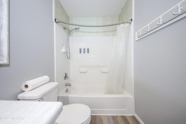 bathroom featuring wood-type flooring, toilet, and shower / tub combo with curtain