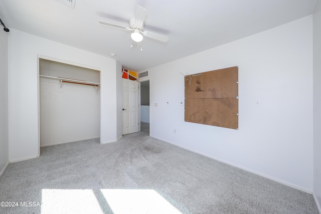 unfurnished bedroom with a closet, ceiling fan, and light colored carpet