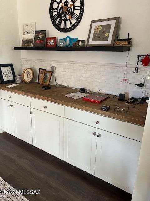 bar featuring white cabinets, dark hardwood / wood-style flooring, tasteful backsplash, and wooden counters