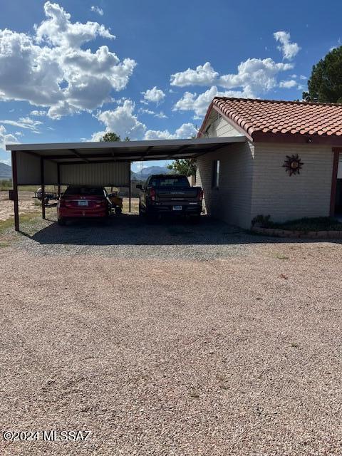 view of vehicle parking featuring a carport