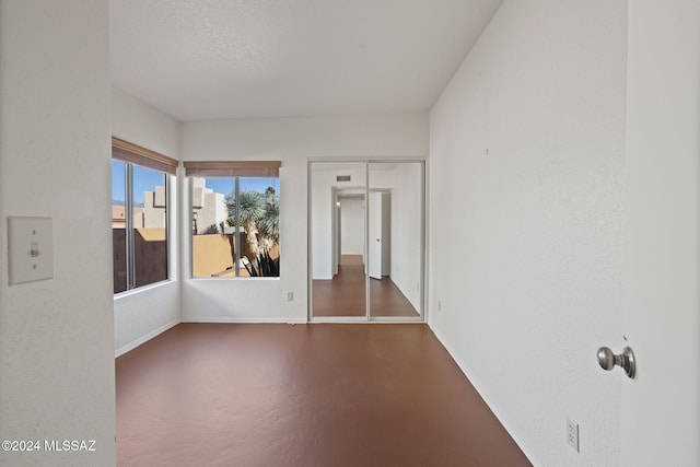 unfurnished room featuring a textured ceiling