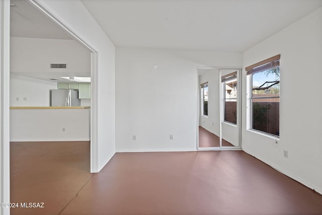 spare room with concrete floors