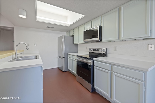 kitchen featuring white cabinets, appliances with stainless steel finishes, and sink