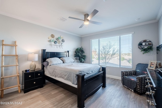 bedroom featuring ceiling fan, light wood-type flooring, and crown molding