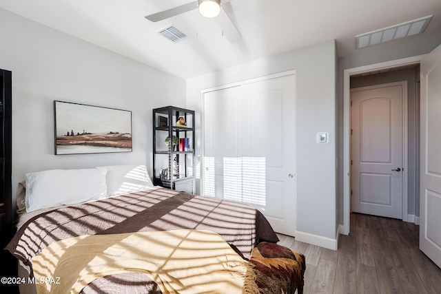 bedroom featuring ceiling fan, a closet, and hardwood / wood-style floors