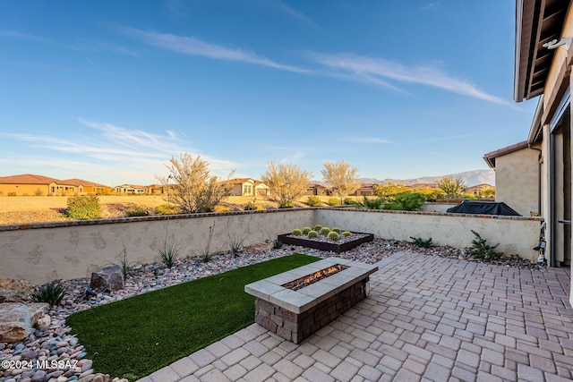 view of patio featuring a fire pit and a mountain view