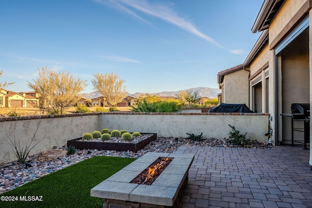 view of patio / terrace featuring a mountain view and an outdoor fire pit