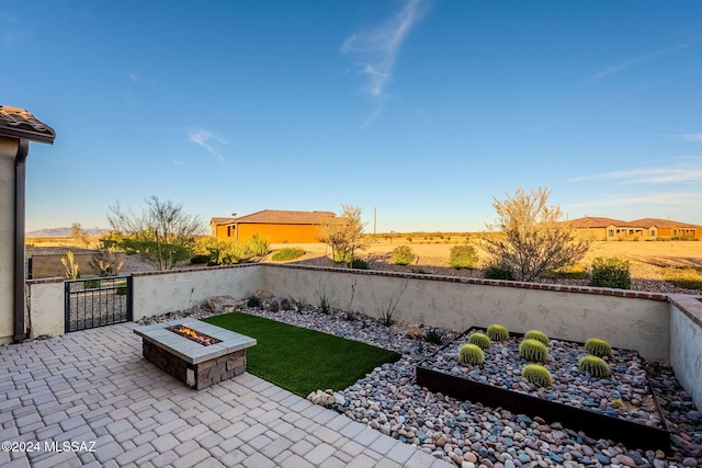 view of yard featuring an outdoor fire pit and a patio