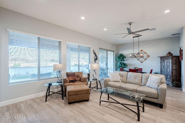 living room featuring ceiling fan and light wood-type flooring