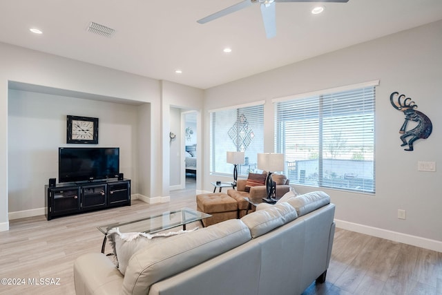 living room featuring ceiling fan and light hardwood / wood-style flooring