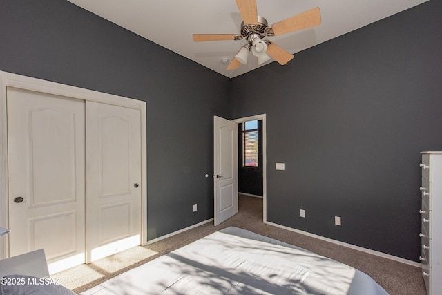 bedroom with ceiling fan, a closet, and dark carpet