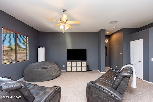 carpeted living room featuring ceiling fan