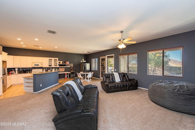 carpeted living room featuring ceiling fan