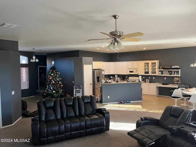 living room featuring ceiling fan and light colored carpet