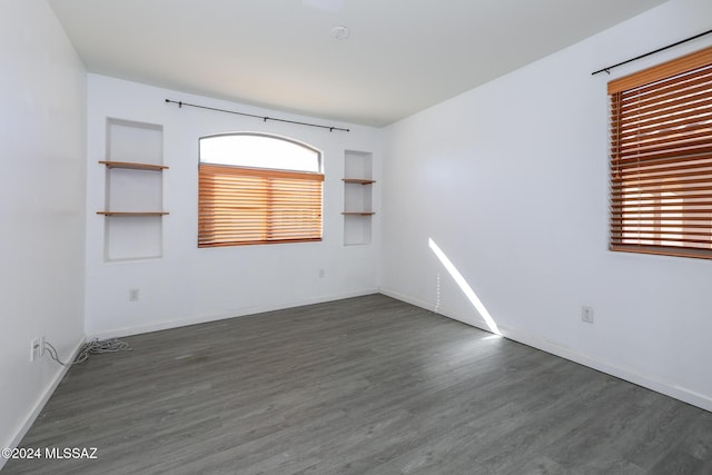 unfurnished room featuring dark hardwood / wood-style floors