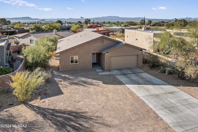 view of front facade with a mountain view and a garage