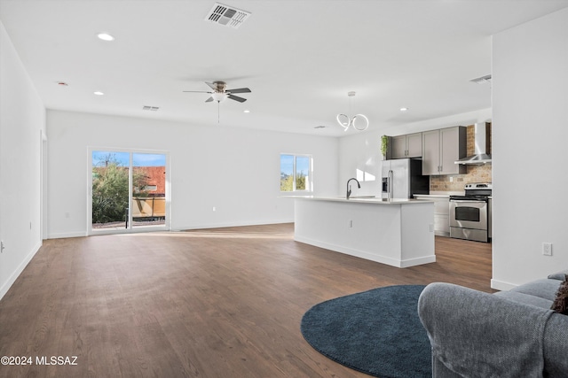 living room featuring ceiling fan, hardwood / wood-style floors, and sink