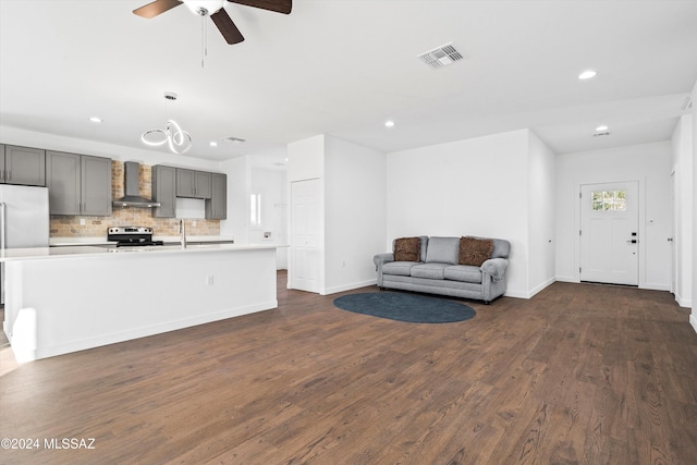 living room with ceiling fan and dark wood-type flooring