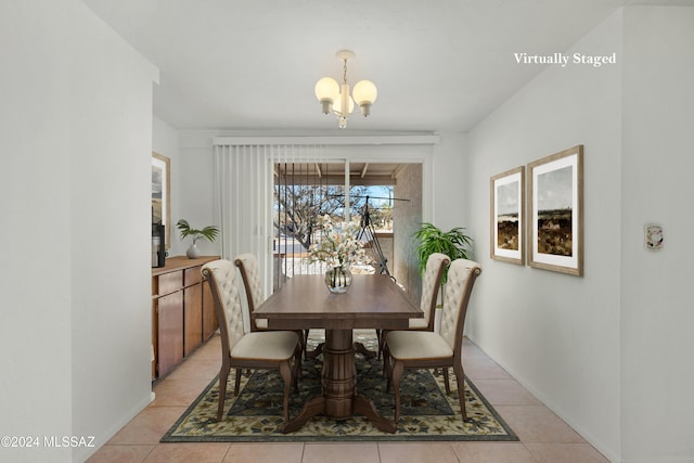 dining space with an inviting chandelier and light tile patterned flooring