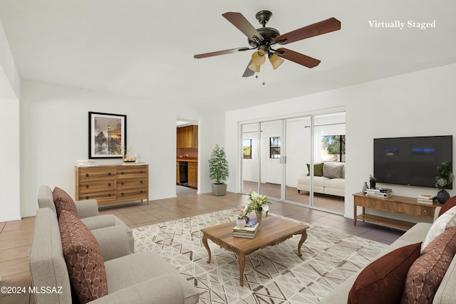 living room with ceiling fan and light tile patterned flooring