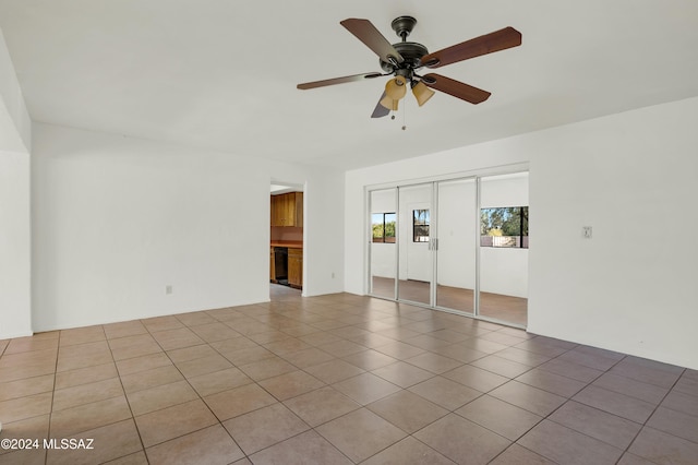 spare room with light tile patterned floors and ceiling fan