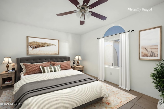 bedroom featuring tile patterned floors and ceiling fan