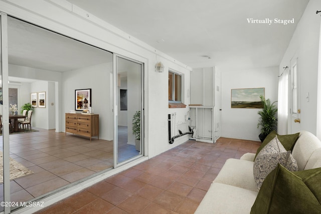 unfurnished living room with light tile patterned flooring