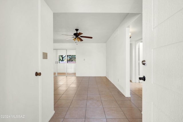 spare room featuring ceiling fan and light tile patterned floors