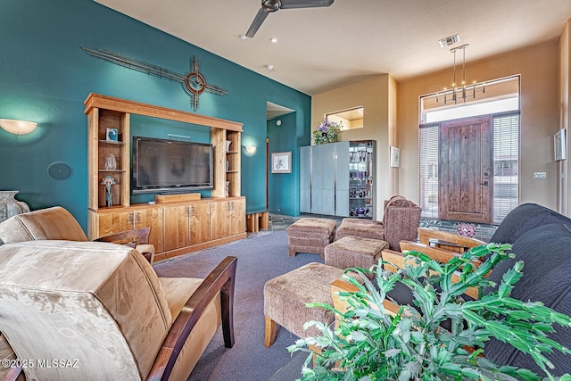 carpeted living room with ceiling fan