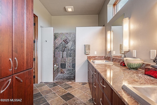 bathroom featuring a shower and vanity