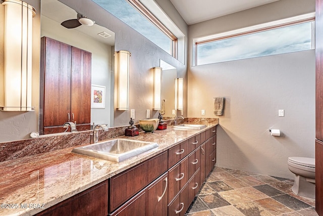 bathroom featuring toilet, vanity, and ornate columns