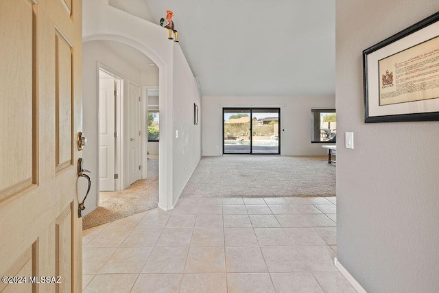 foyer featuring light carpet