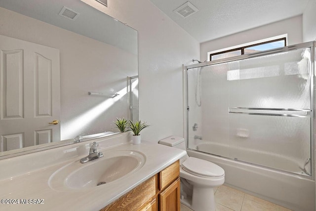 full bathroom with tile patterned flooring, vanity, toilet, and enclosed tub / shower combo