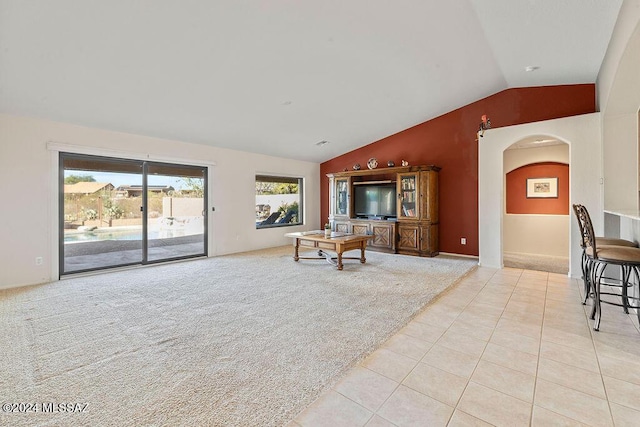 living room featuring light colored carpet and vaulted ceiling