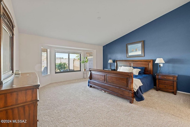 carpeted bedroom with vaulted ceiling