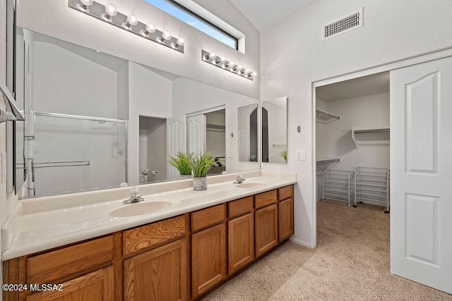 bathroom with vanity and lofted ceiling