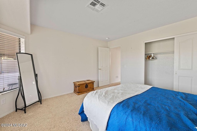 bedroom with light carpet and a closet