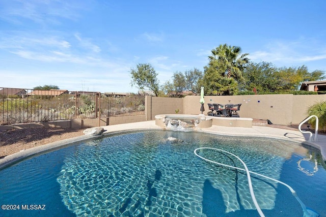 view of swimming pool featuring pool water feature and a patio area