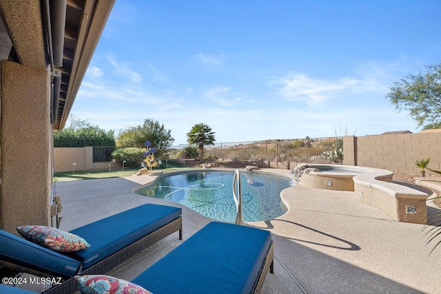 view of swimming pool with a patio area and an in ground hot tub