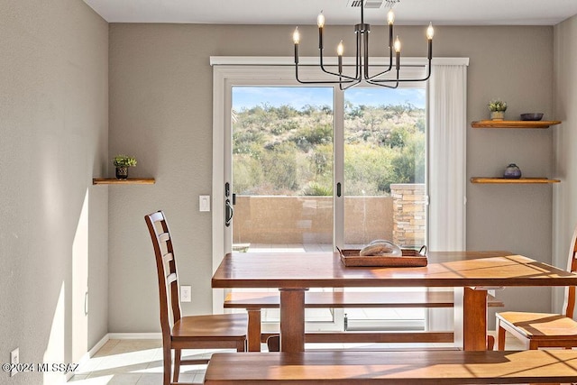 dining space featuring light tile patterned floors and a chandelier