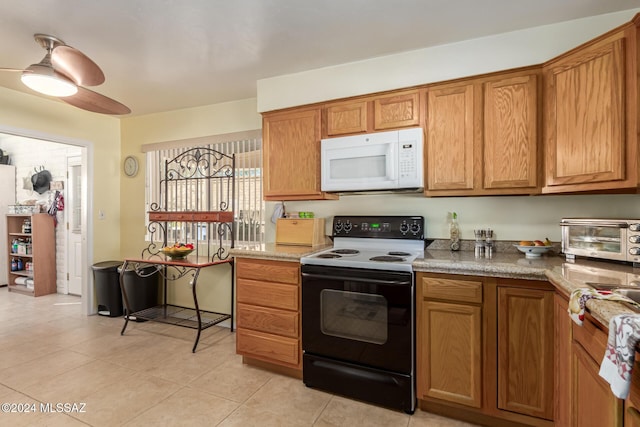 kitchen featuring electric range, ceiling fan, and light tile patterned flooring