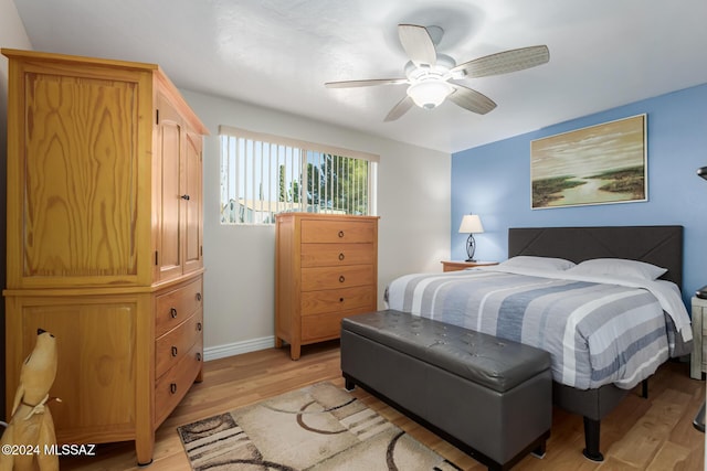 bedroom with ceiling fan and light wood-type flooring