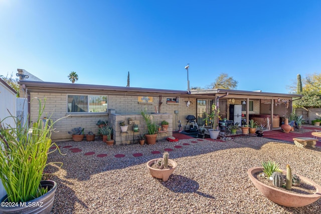 view of front of home with a patio area and a hot tub