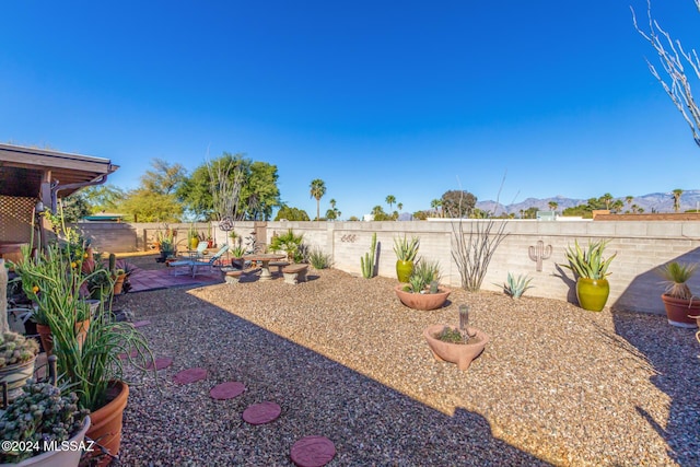 view of yard with a mountain view and a patio