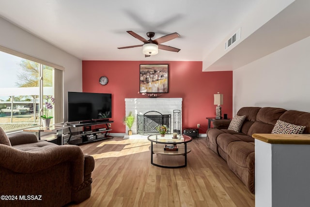 living room with wood-type flooring and ceiling fan