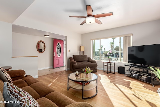 tiled living room featuring ceiling fan