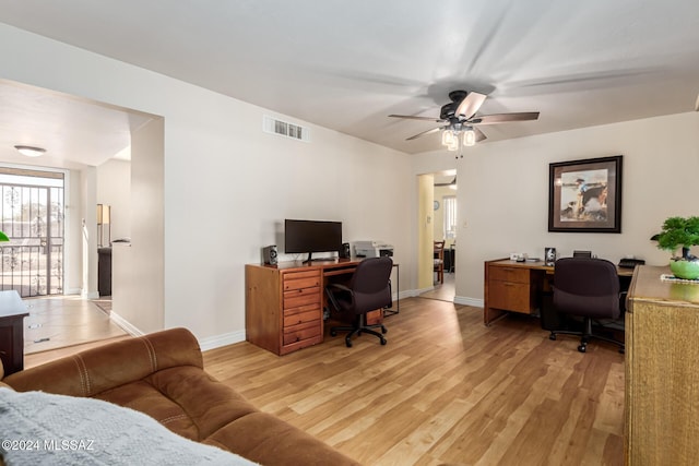 office with ceiling fan and light hardwood / wood-style floors