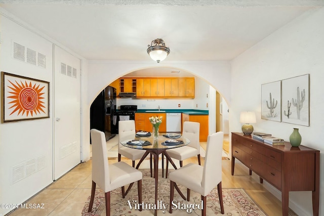 dining room with sink and light tile patterned flooring